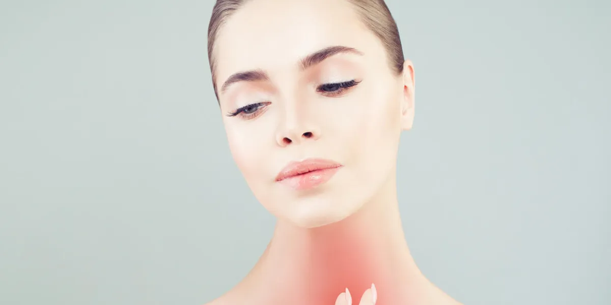 young woman with a sore throat woman puts hands on the neck young woman with a sore throat woman puts hands on the neck