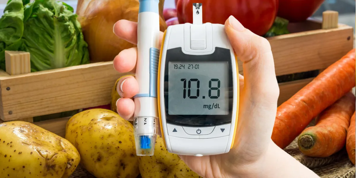 hand holds glucometer for measuring glucose level vegetables in background diabetic diet and diabetes concept hand holds glucometer for measuring glucose level vegetables in background diabetic diet and diabetes concept