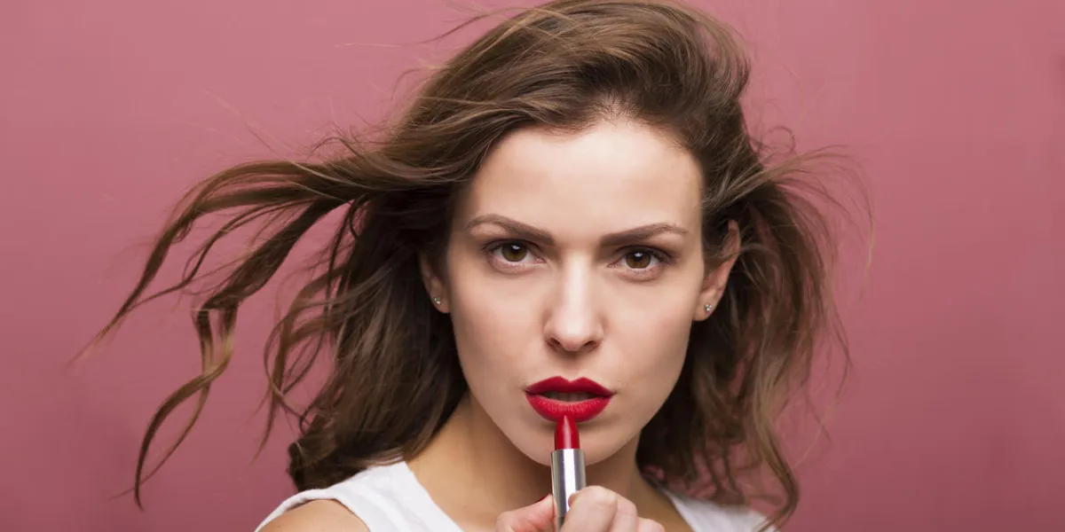 jolie femme coiffant ses cheveux avec un sèche-cheveux