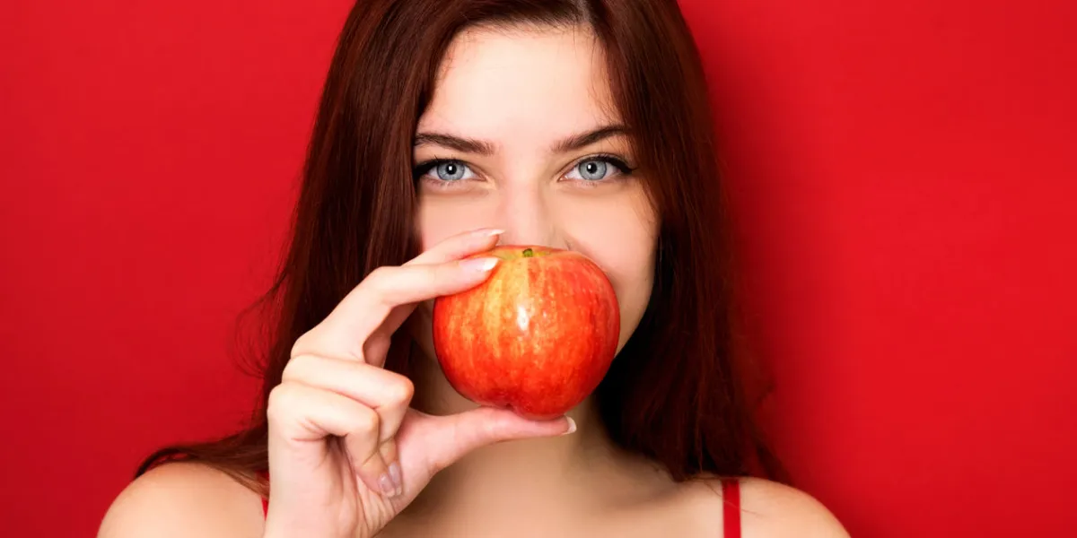 young woman holding red apple young woman holding red apple