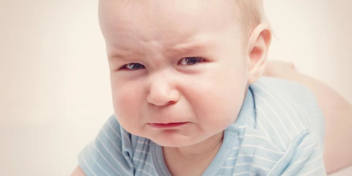 eight month old baby crying sad child portrait