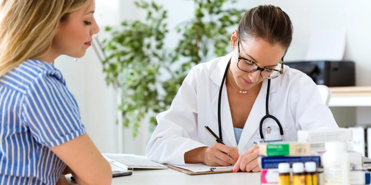 portrait of female doctor explaining diagnosis to her patient portrait of female doctor explaining diagnosis to her patient