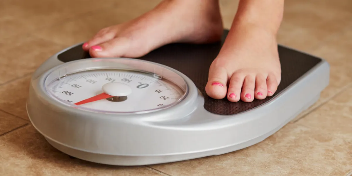female bare feet on weight scale in bathroom female bare feet on weight scale in bathroom