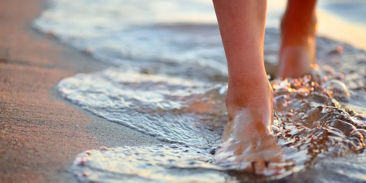 female feet step on the sea wave summer vacations concept female feet step on the sea wave summer vacations concept