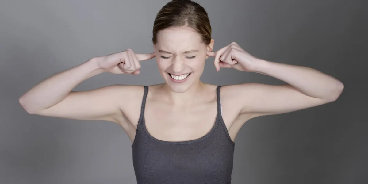 pretty young woman holding her ears with fingers pretty young woman holding her ears with fingers