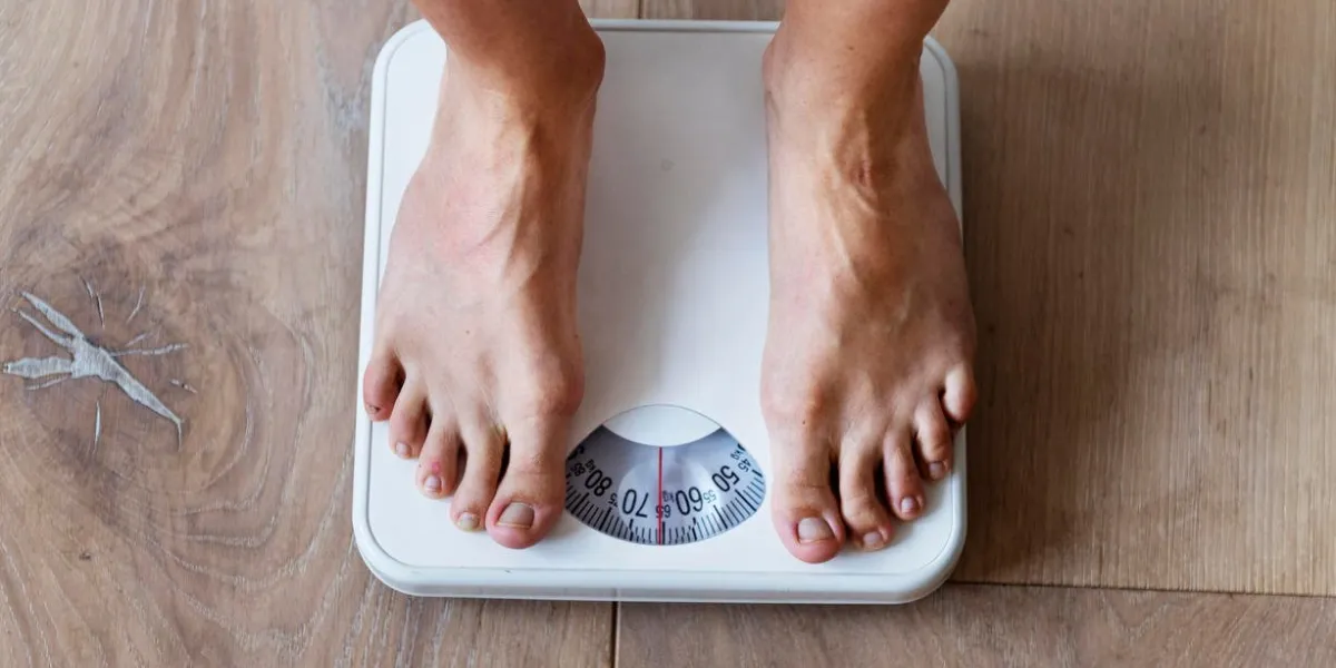 pregnant woman weighing herself