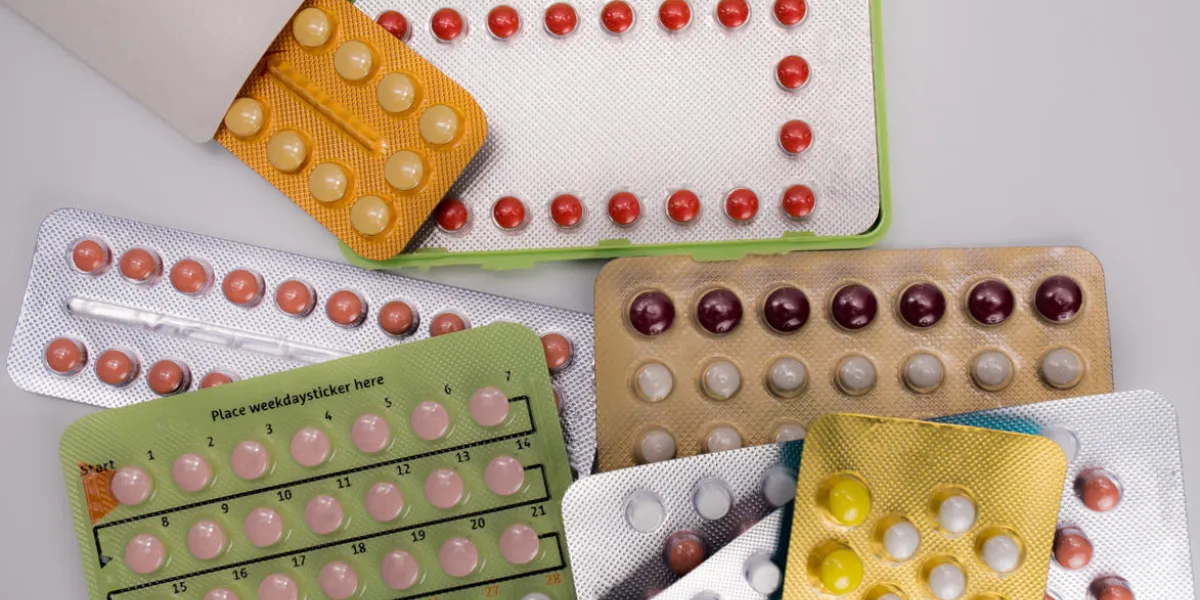 pile of birth control pills with modern packaging on white background pile of birth control pills with modern packaging on white background