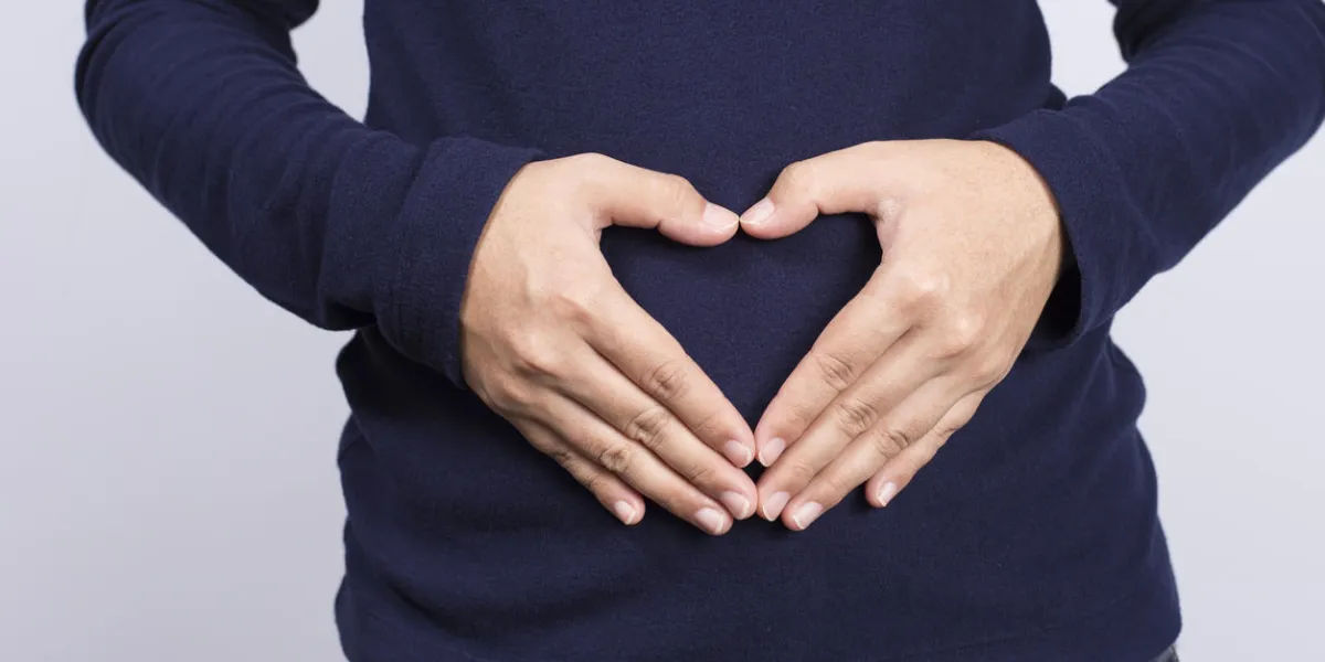 woman forming heart shape on belly woman forming heart shape on belly