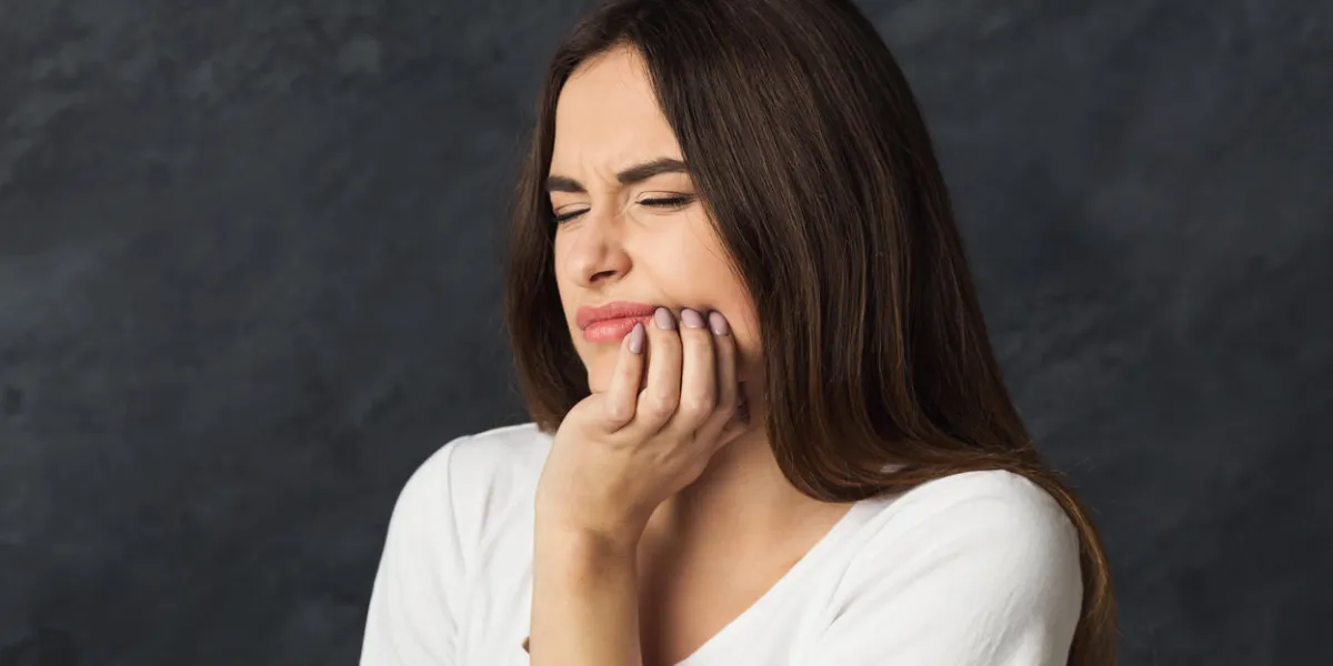 portrait of young woman having toothache attractive girl with pain grimace at dark studio background health care and dental issues concept, copy space portrait of young woman having toothache attractive girl with pain grimace at dark studio background health care and dental issues concept, copy space