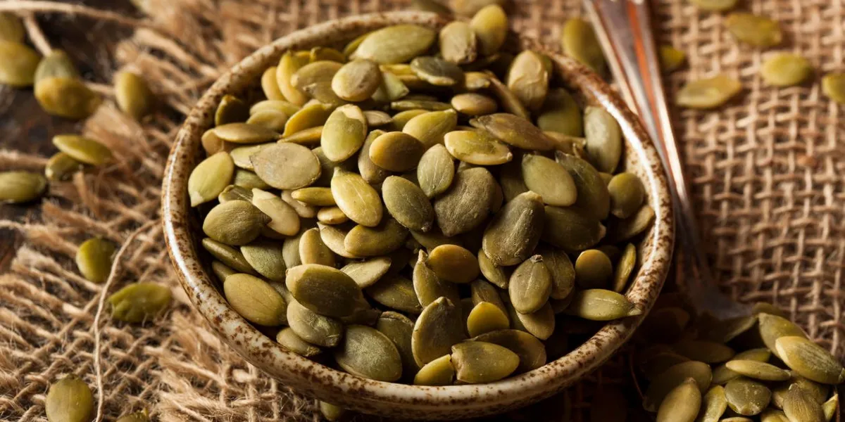 raw organic pumpkin pepita seeds in a bowl