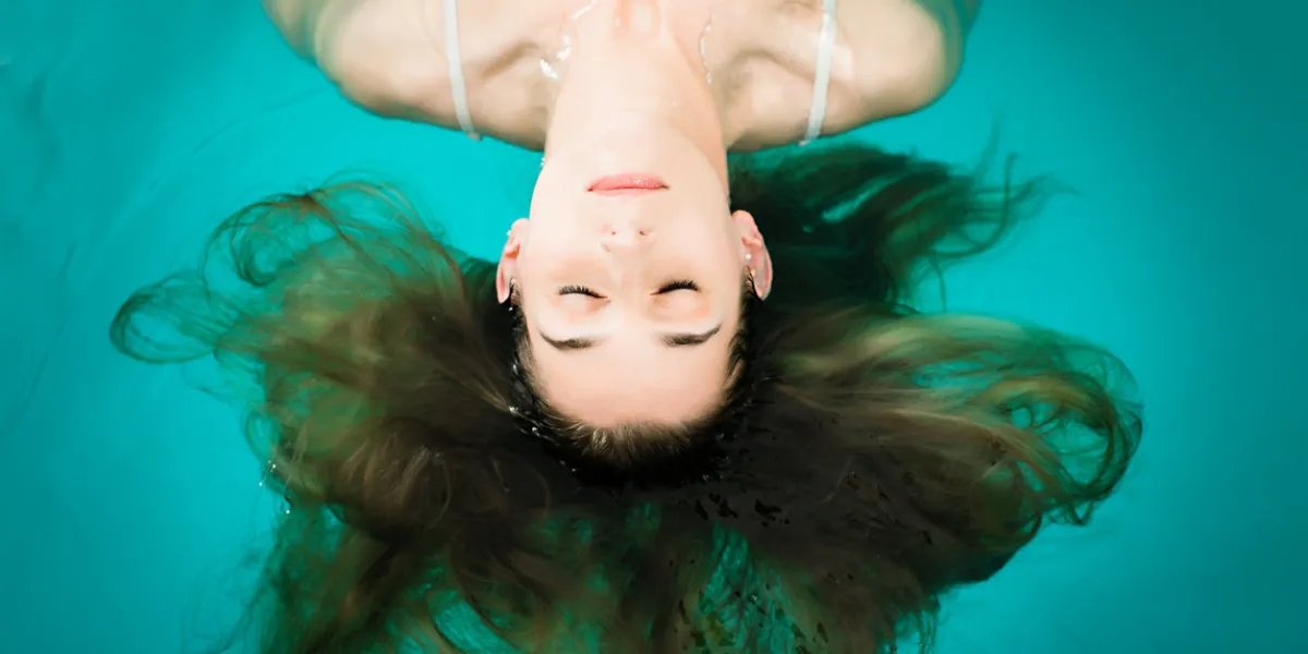 wellness - young woman floating in spa or swimming pool, she is very relaxed wellness - young woman floating in spa or swimming pool, she is very relaxed