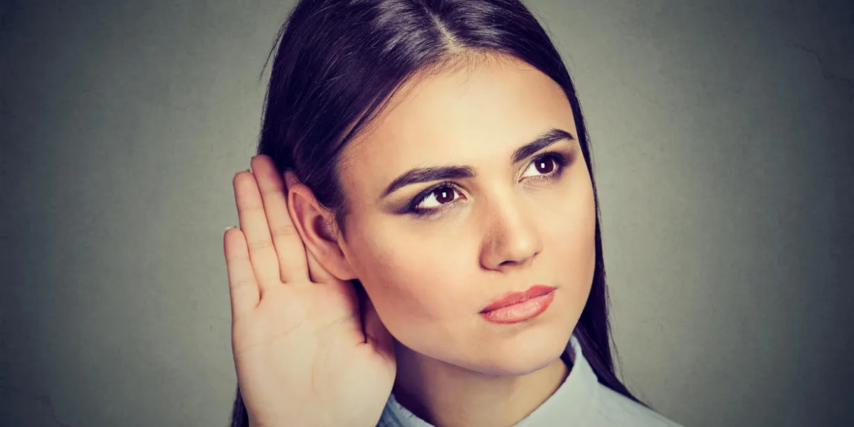 woman with hand to ear gesture listening carefully woman with hand to ear gesture listening carefully