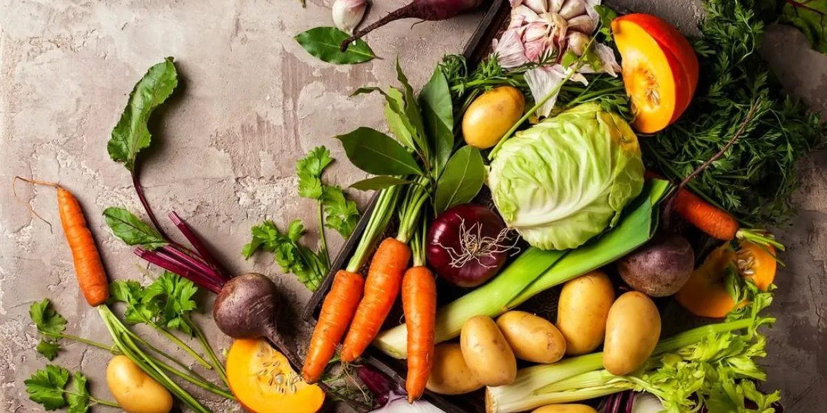 variety of fresh raw vegetable ingredients for cooking of vegetable soup or stew autumn vegetable still life on rustic vintage background top view