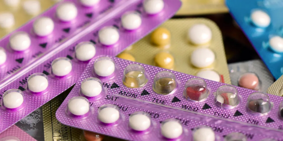 oral contraceptive pill on pharmacy counter with colorful pills strips background oral contraceptive pill on pharmacy counter with colorful pills strips background