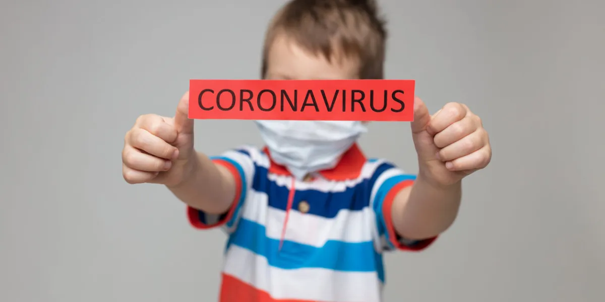 young child wearing a respiratory mask as a prevention against the deadly coronavirus covid-19