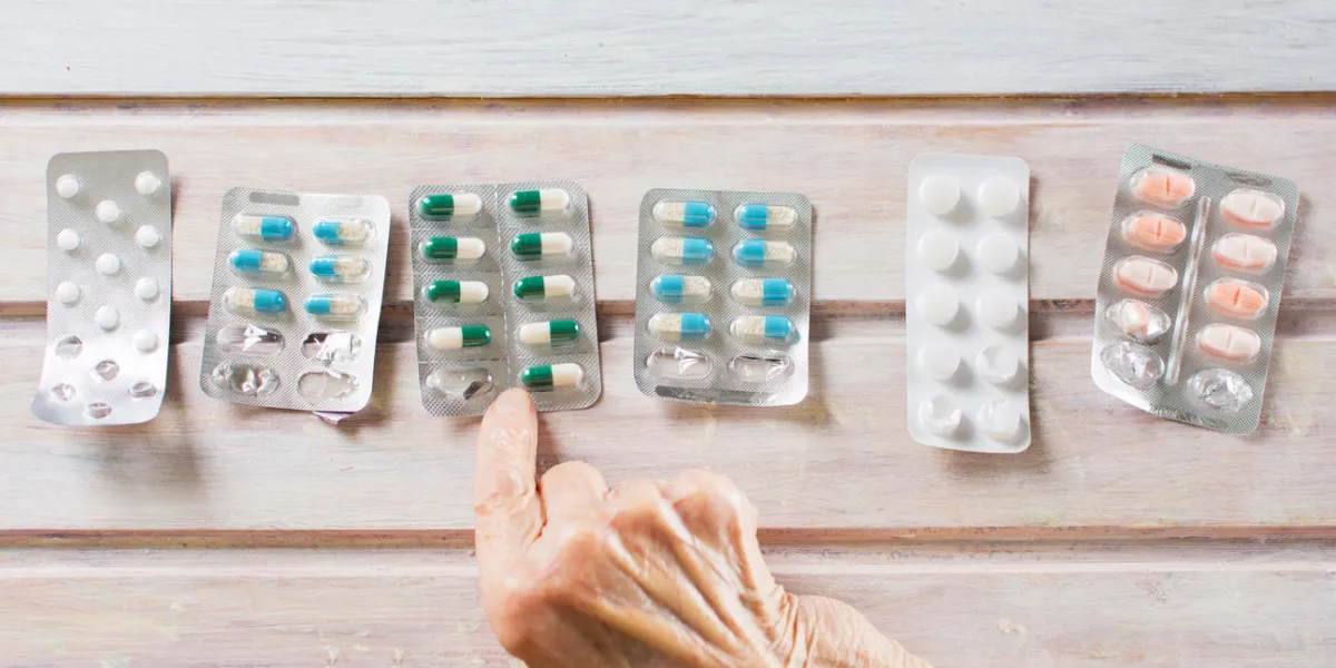 senior woman hands picking her today medical pills senior woman hands picking her today medical pills