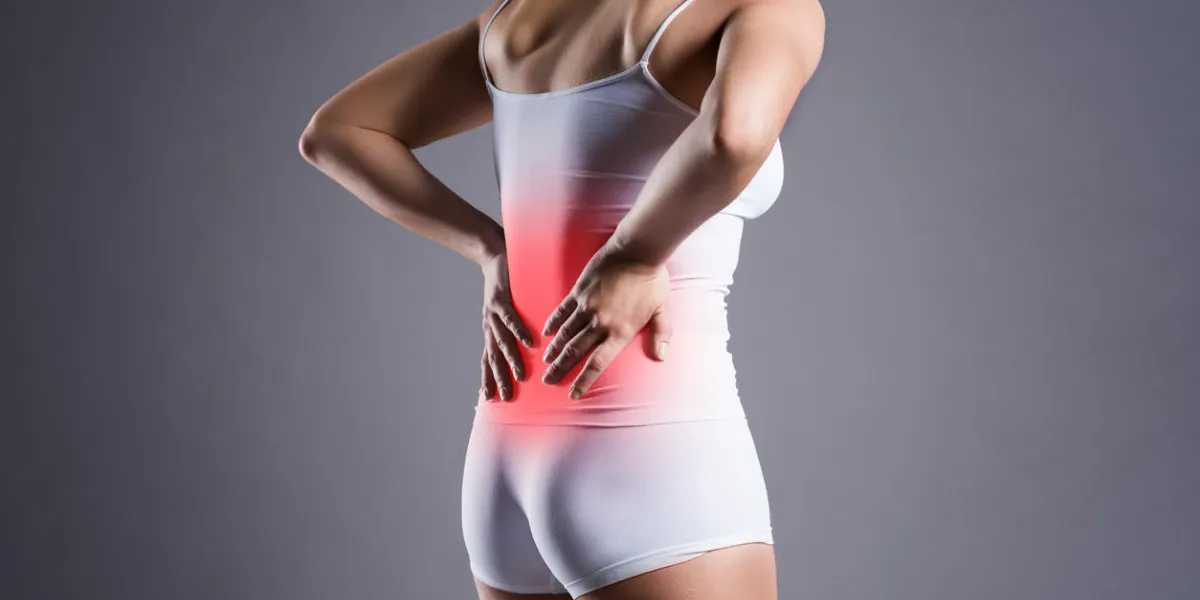 back pain, kidney inflammation, ache in woman's body on gray background back pain, kidney inflammation, ache in woman's body on gray background