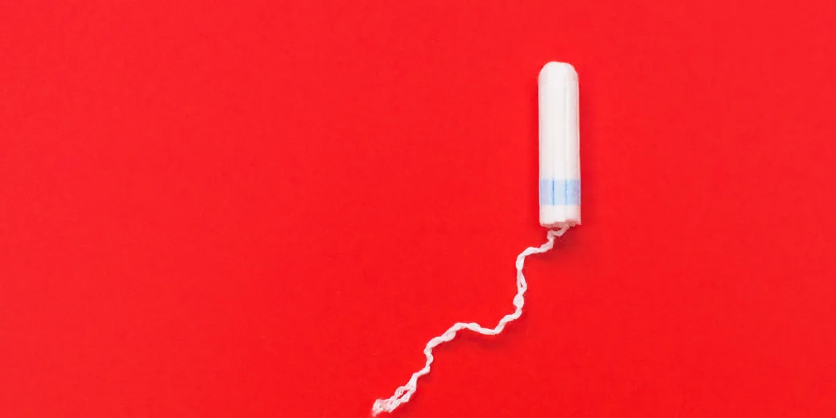 hygienic white tampon for women cotton swab menstruation, means of protection tampons on a red background hygienic white tampon for women cotton swab menstruation, means of protection tampons on a red background