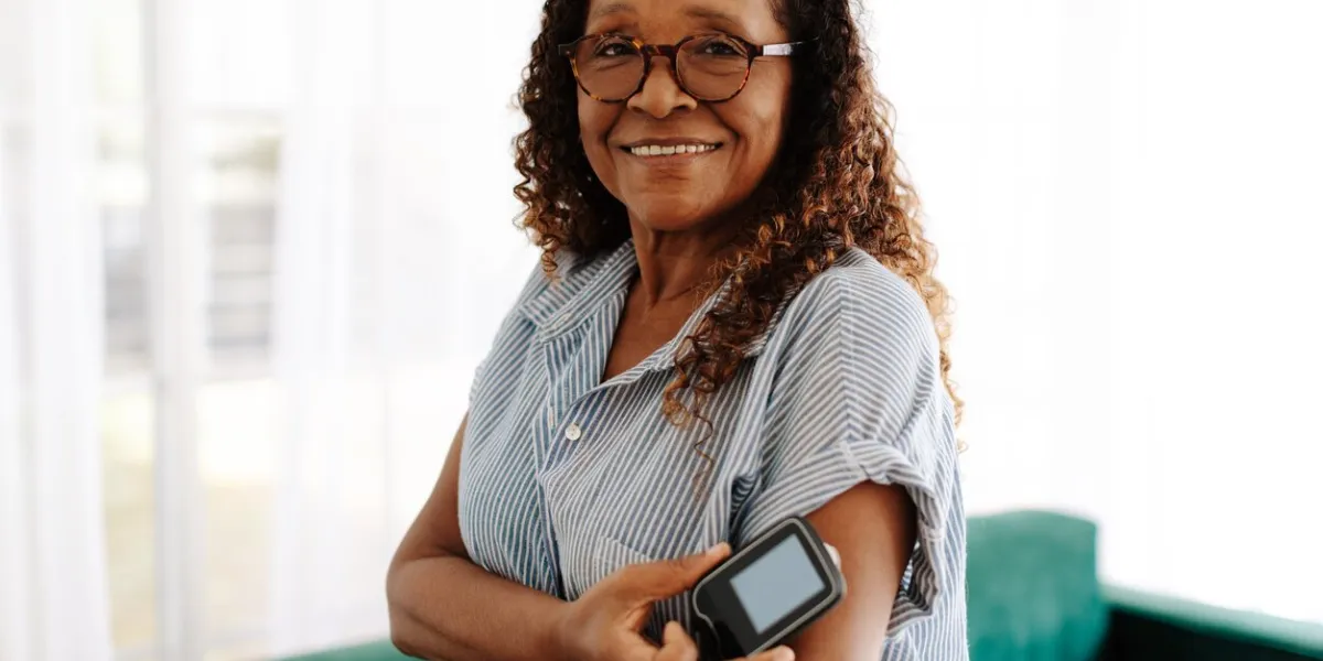 portrait of a woman using continuous glucose monitoring to manage her diabetes at home mature woman using the latest health technology to measure and keep her blood glucose levels under control portrait of a woman using continuous glucose monitoring to manage her diabetes at home mature woman using the latest health technology to measure and keep her blood glucose levels under control