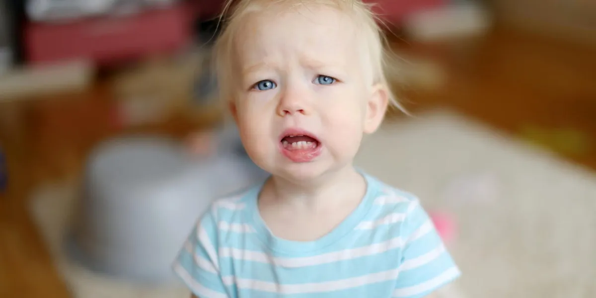 angry upset toddler girl at home