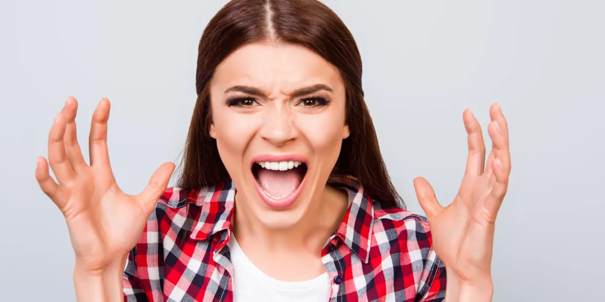 going crazy and insane close up portrait of shouting stressed young girl, ready to attack, on pure light background, wearing casual checkered shirt going crazy and insane close up portrait of shouting stressed young girl, ready to attack, on pure light background, wearing casual checkered shirt