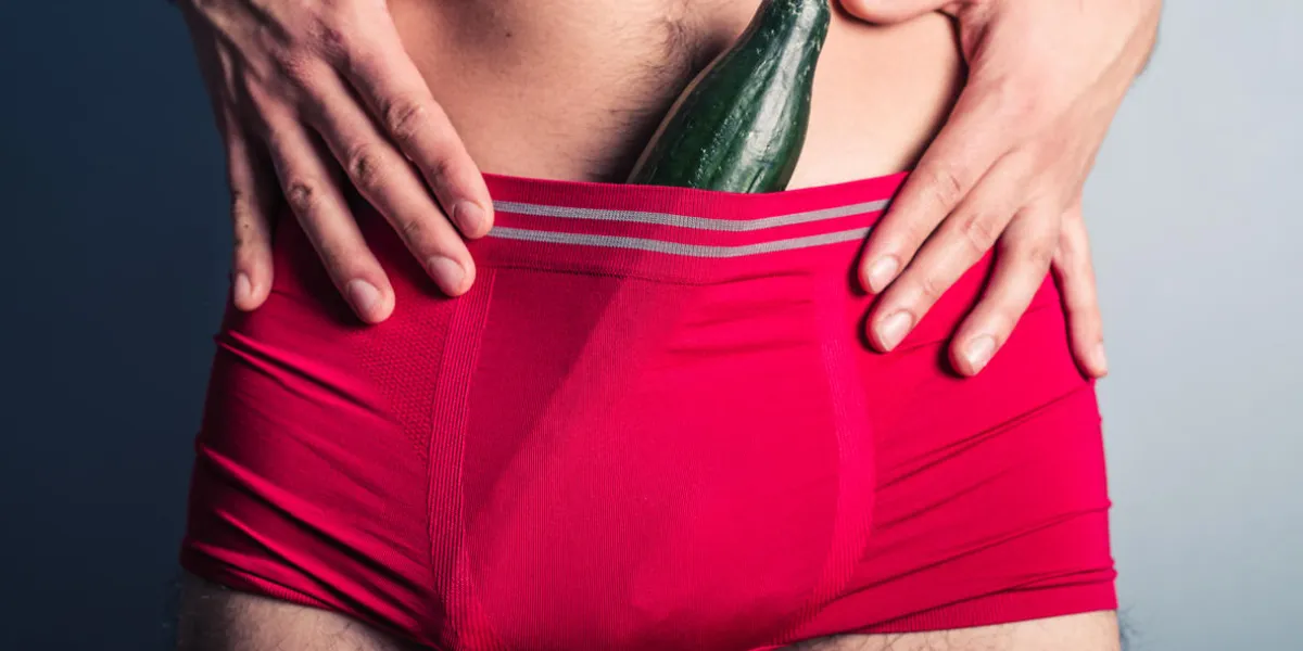 a young man has stuffed a large cucumber down his underpants a young man has stuffed a large cucumber down his underpants