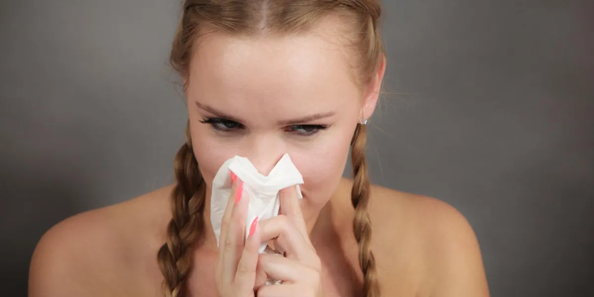 sickness, seasonal virus problem concept woman being sick having flu sneezing into tissue sickness, seasonal virus problem concept woman being sick having flu sneezing into tissue