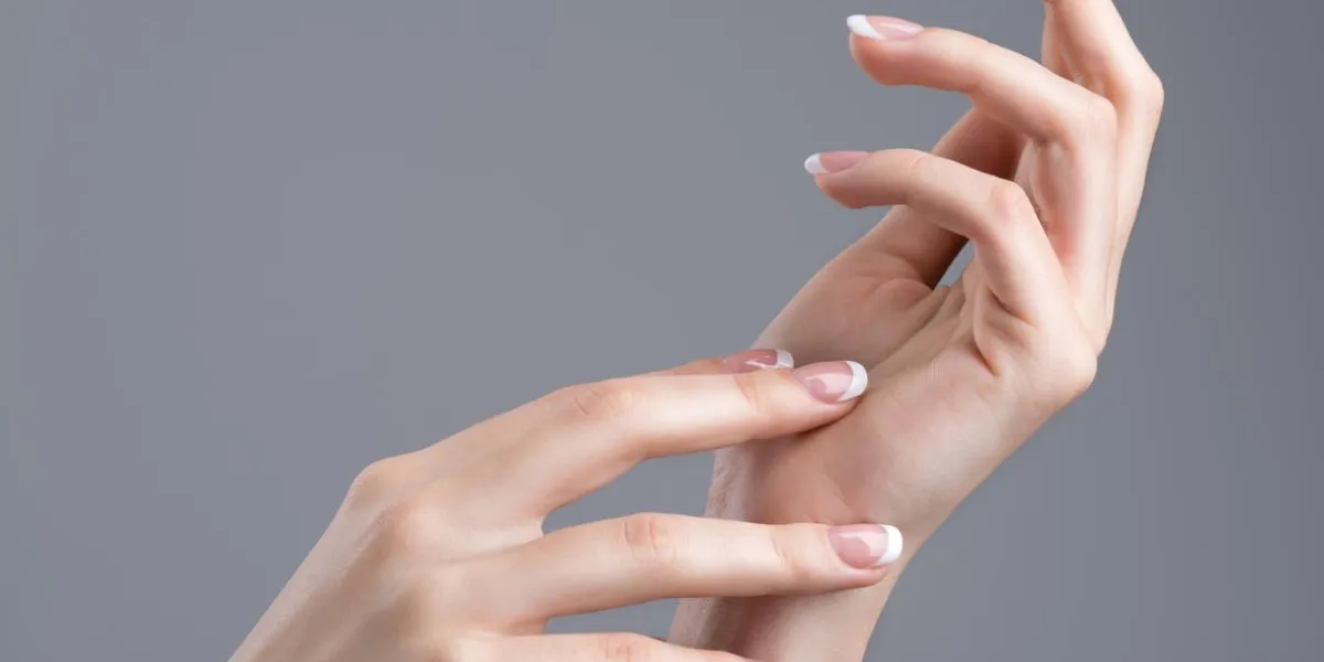 beautiful female hands with french manicure on nails