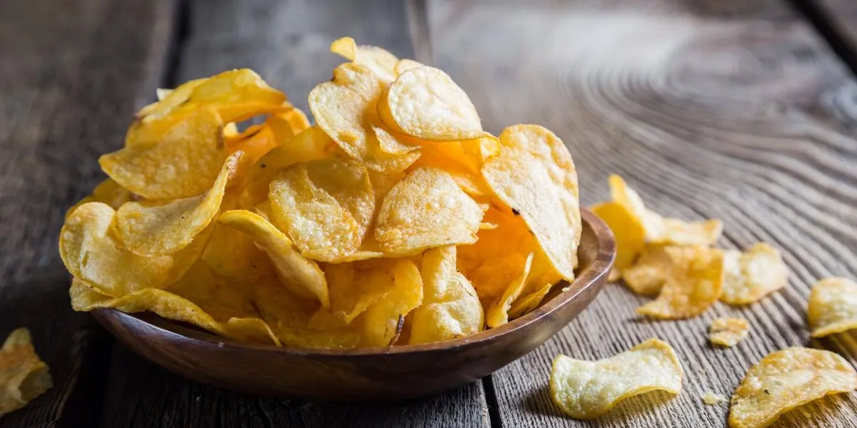 potato chips on a wooden table potato chips on a wooden table