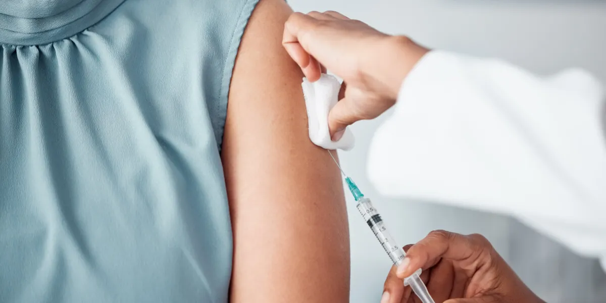 hands, medical and doctor with patient for vaccine in a clinic for healthcare treatment for prevention closeup of a nurse doing a vaccination injection with a needle syringe in a medicare hospital