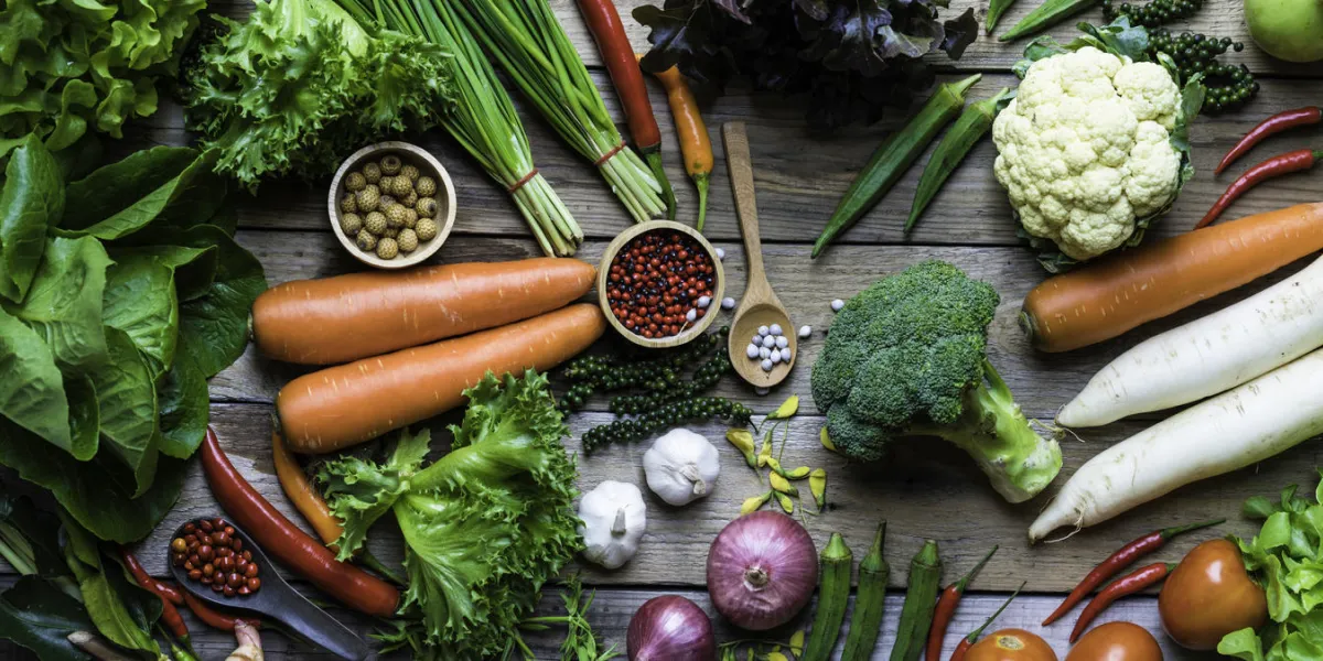 panorama of organic and raw vegetables on a wooden table panorama of organic and raw vegetables on a wooden table