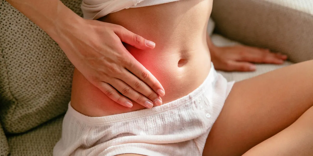 menstruation concept woman holds on to the belly with her hands with stomach ache because of gastritis or menstruation close-up menstruation concept woman holds on to the belly with her hands with stomach ache because of gastritis or menstruation close-up
