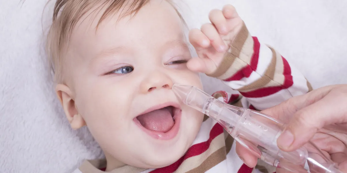 mother using nasal aspiration for infant, mucus suction
