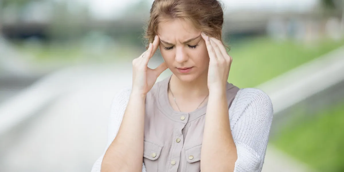 portrait of stressed beautiful woman walking on the street and holding her head with hands trying to remember something or having headache attractive model suffering from pain outdoors in summer portrait of stressed beautiful woman walking on the street and holding her head with hands trying to remember something or having headache attractive model suffering from pain outdoors in summer