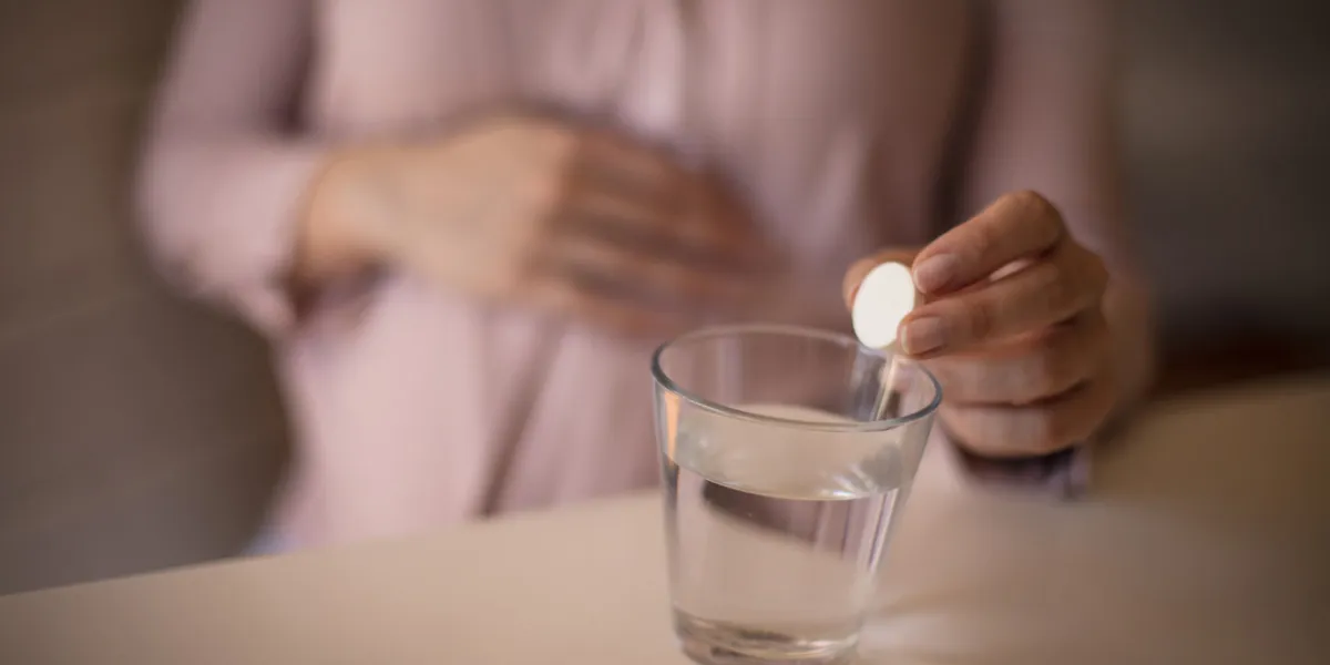 enter as many vitamins as possible into your body woman taking a pill close up focus on hand enter as many vitamins as possible into your body woman taking a pill close up focus on hand