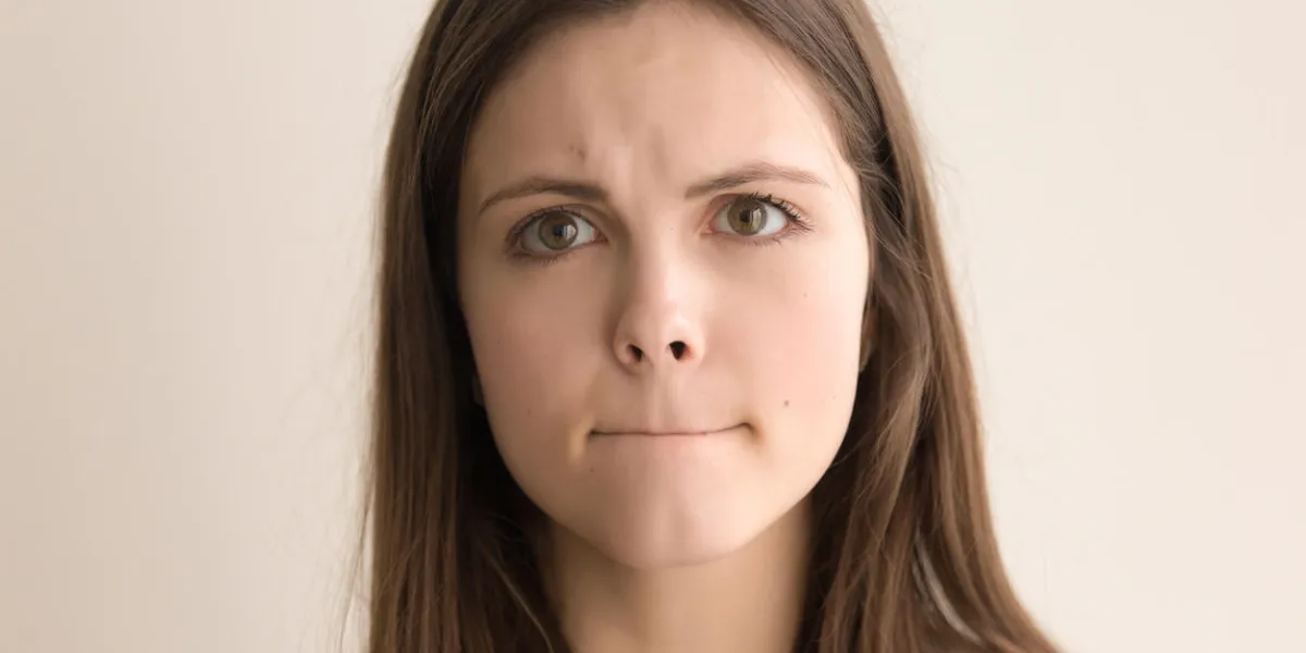 headshot portrait of indecisive young woman beautiful teen girl with pursed lips and worried facial expression looking at camera nervous tension, bad feelings and stress close up front view