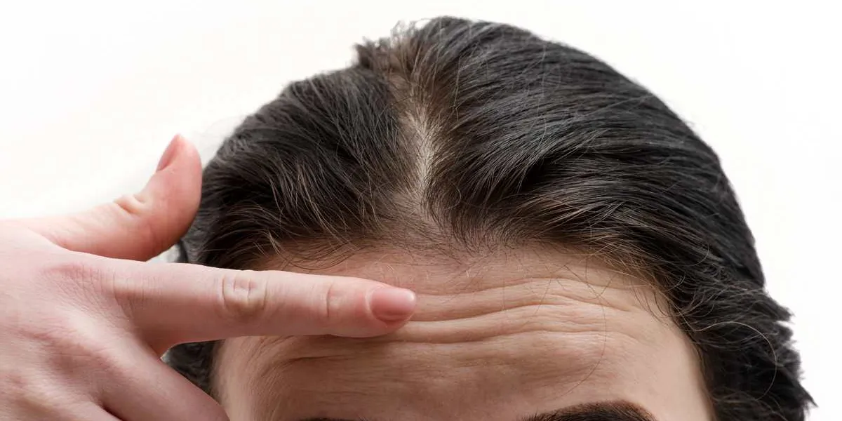 girl points finger at the wrinkles on forehead young brunette girl with skin problems needs anti-aging anti-wrinkle creams, aids for caring adult skin young woman checking wrinkles on her forehead girl points finger at the wrinkles on forehead young brunette girl with skin problems needs anti-aging anti-wrinkle creams, aids for caring adult skin young woman checking wrinkles on her forehead