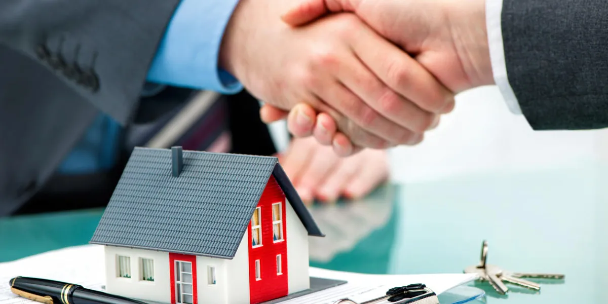 estate agent shaking hands with customer after contract signature estate agent shaking hands with customer after contract signature
