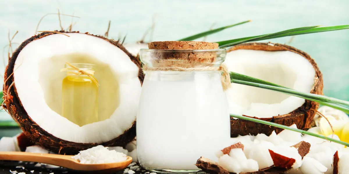 coconut milk glass jar with nuts and oil bottles, fresh coconut flakes coconut milk glass jar with nuts and oil bottles, fresh coconut flakes