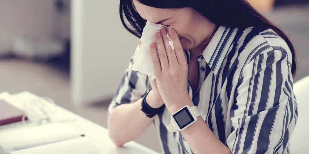 respiratory disease nice pleasant young woman holding a paper tissue and sneezing while having a respiratory disease