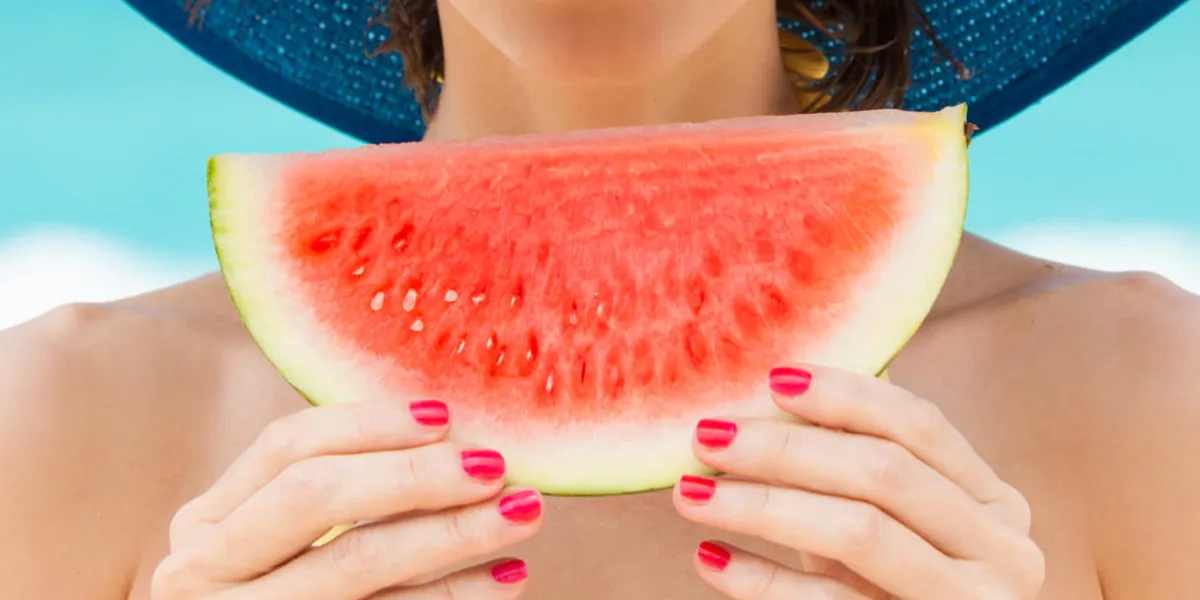 fun beach summer holiday concept woman holding watermelon on the beach