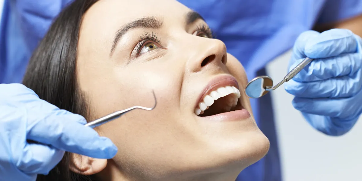 young woman having check up and dental exam at dentist