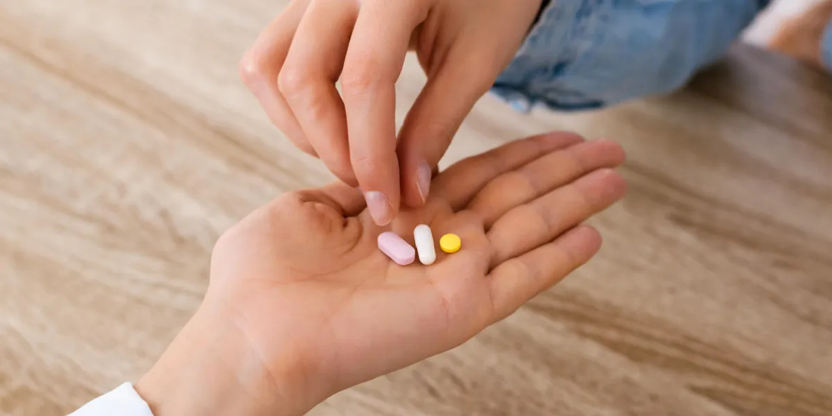 close up of an nurse's hand giving pills