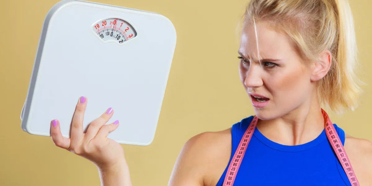 fit fitness woman with scale frustrated angry blonde girl holding weight scales time for slimming weightloss, diet and healthy lifestyles concept fit fitness woman with scale frustrated angry blonde girl holding weight scales time for slimming weightloss, diet and healthy lifestyles concept