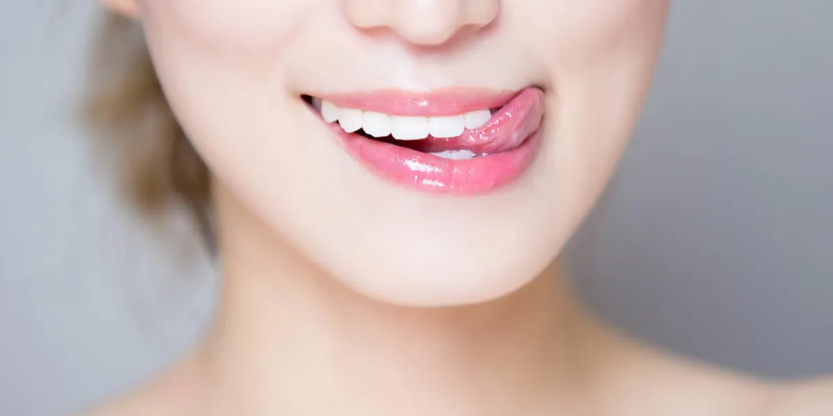close up of beauty woman teeth and tongue