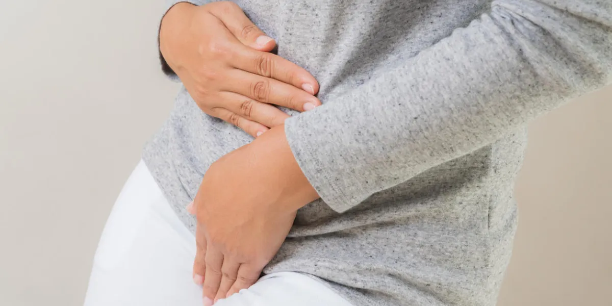 young woman having painful stomachache with hands holding pressing her crotch lower abdomen medical or gynecological problems, healthcare concept young woman having painful stomachache with hands holding pressing her crotch lower abdomen medical or gynecological problems, healthcare concept
