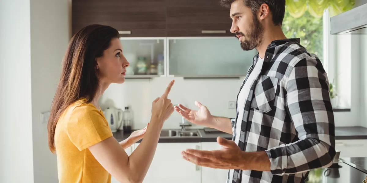 couple having argument in kitchen at home