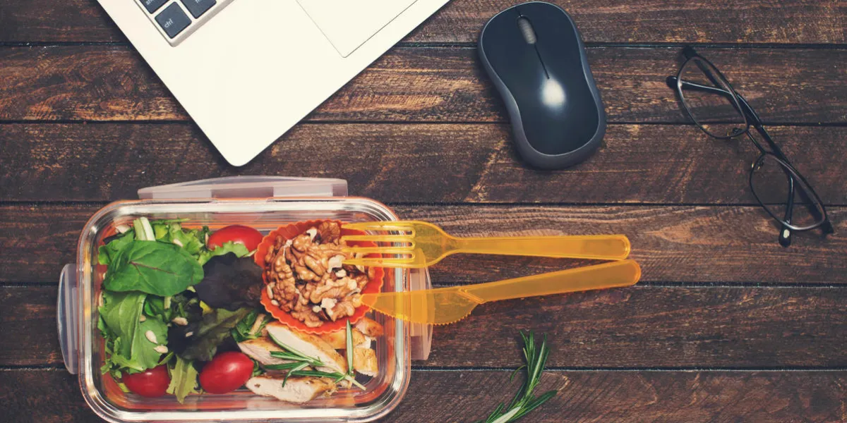 healthy business lunch at workplace vegetables and fried chicken lunch box on working desk with laptop and glasses healthy business lunch at workplace vegetables and fried chicken lunch box on working desk with laptop and glasses