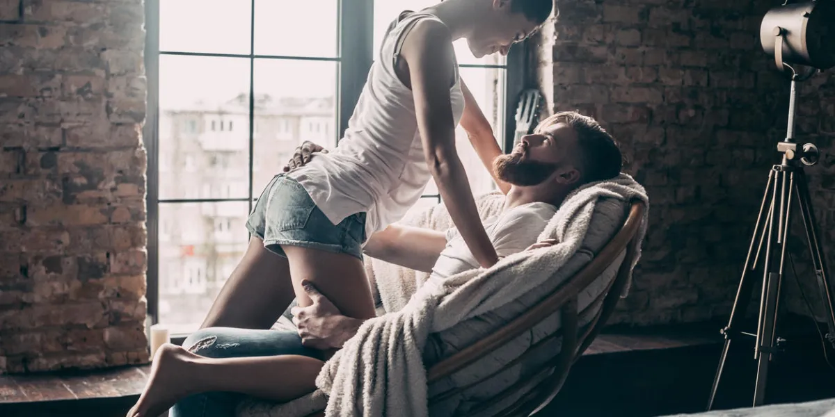 young passionate couple looking on each other while spending free time at home