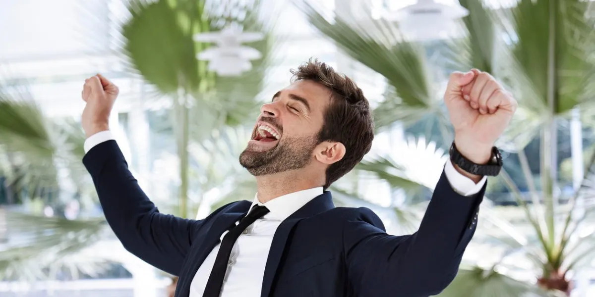 cheering businessman in smart suit